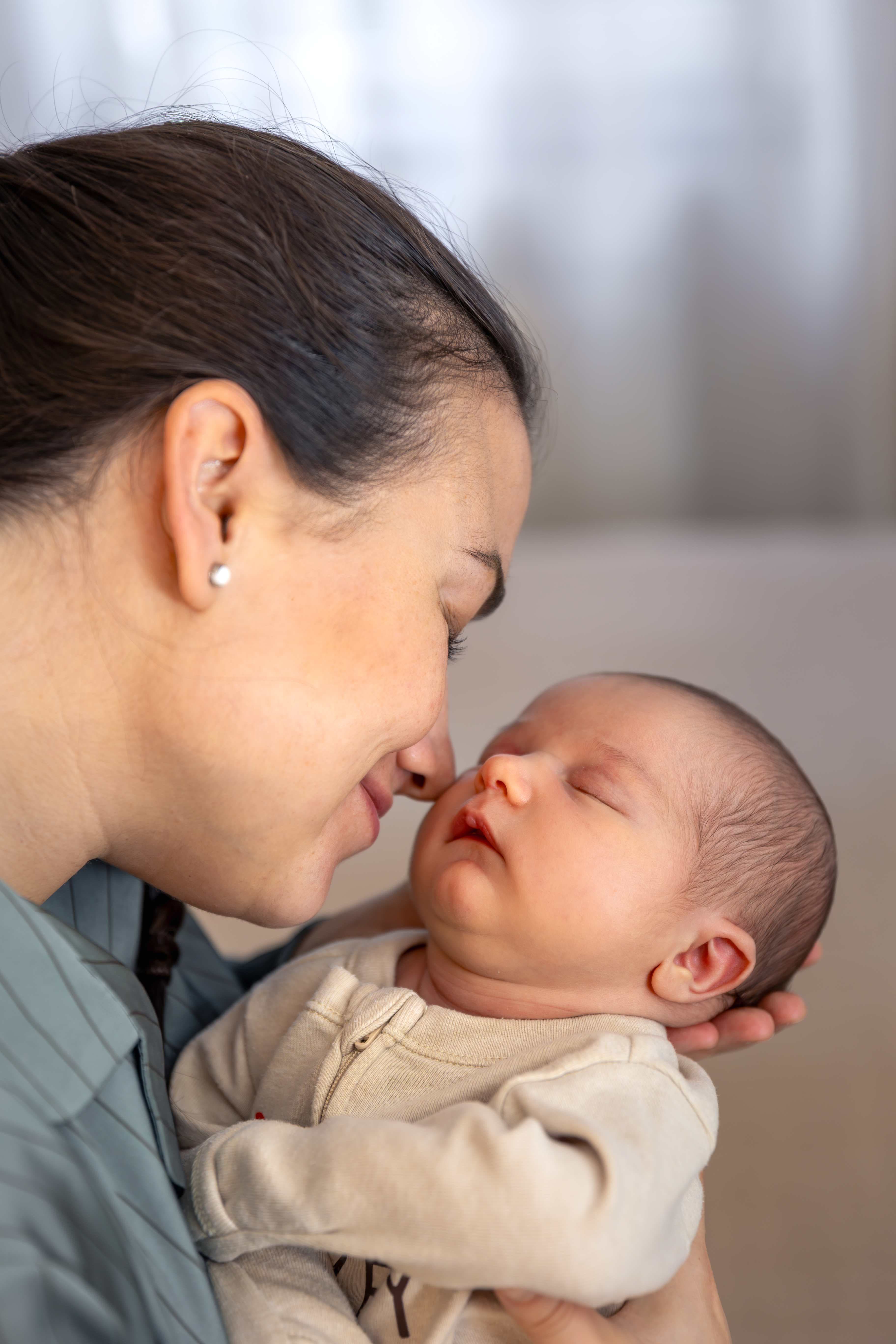 Mother kissing her baby after a successful IVF journey with Angel Fertility